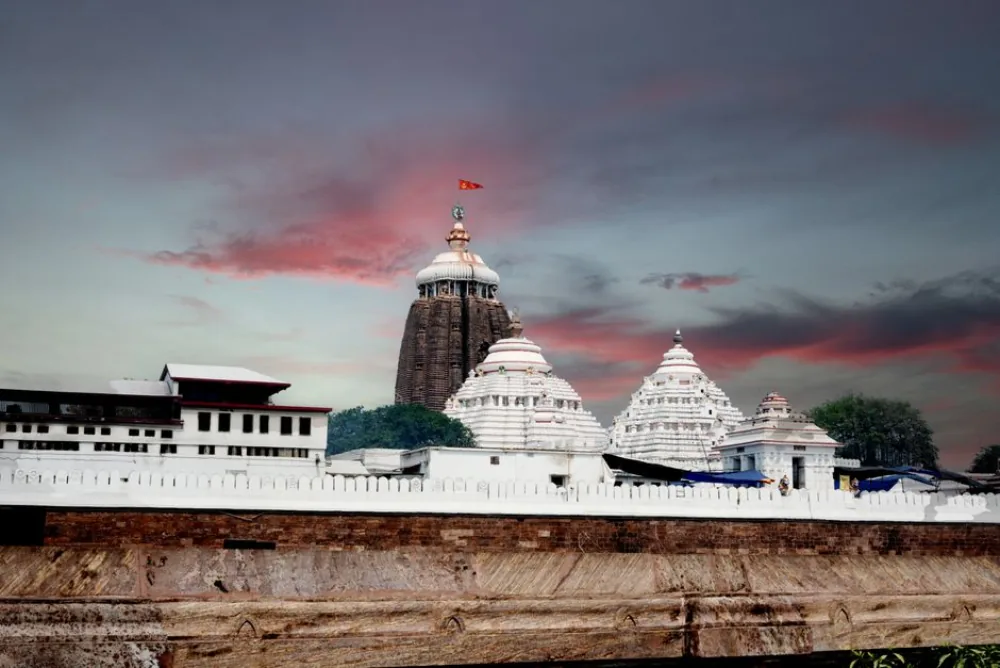 Shree Jagannath Temple, Puri — the dark Vimana tower and sacred flag at dusk, Odisha